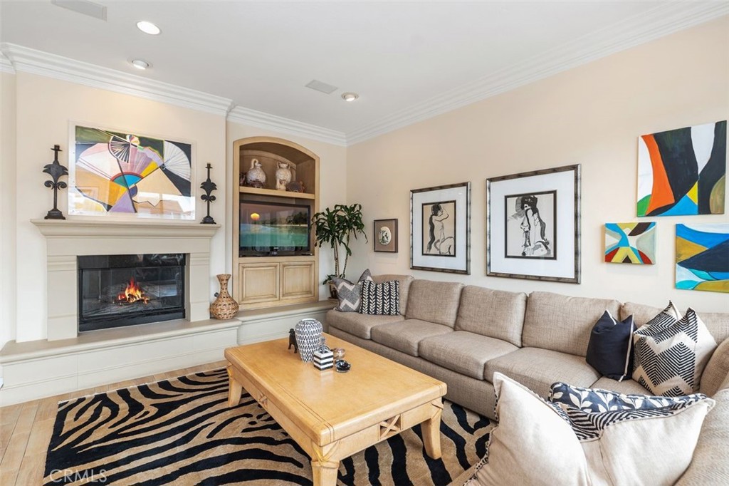 354 Salta Verde Point Long Beach, CA 90803 - Photo 7 of 33 a living room with furniture a flat screen tv and a fireplace