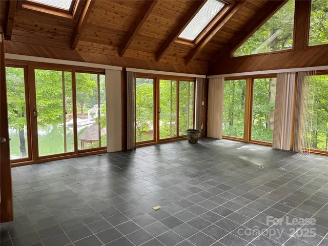 a view of room with balcony and furniture
