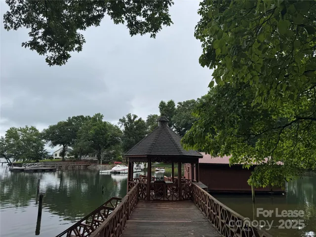 a view of a wooden deck and lake view