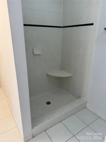 a bathroom with bathtub and window