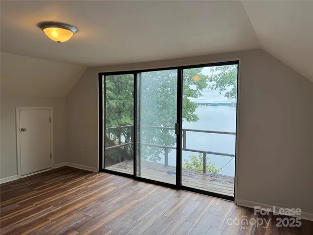 a view of a room with wooden floor