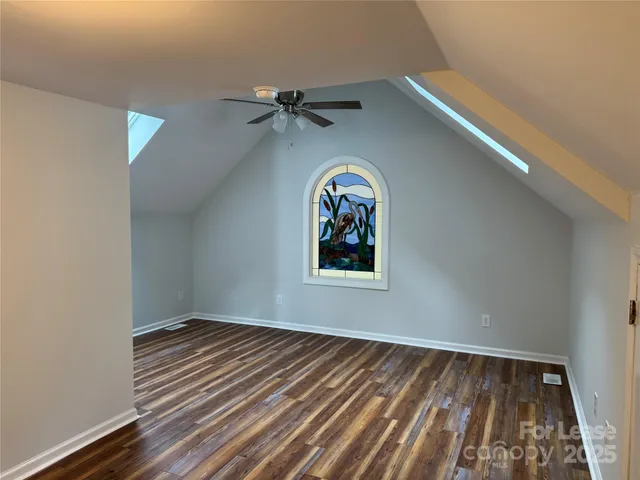 a view of a room with wooden floor