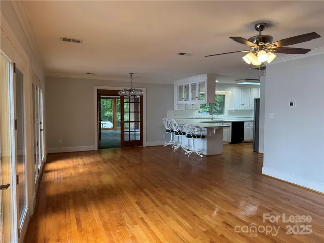a view of a livingroom with furniture and chandelier fan