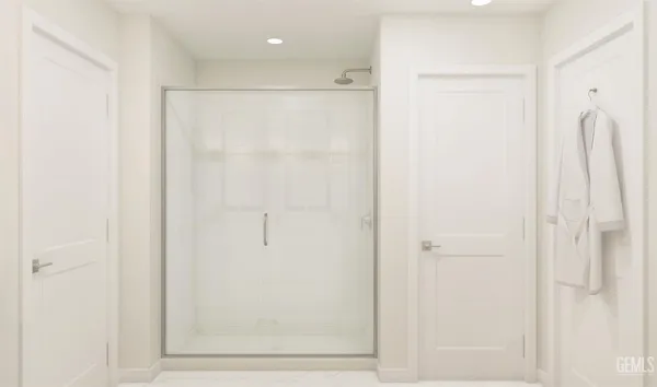 a bathroom with a shower and a glass door