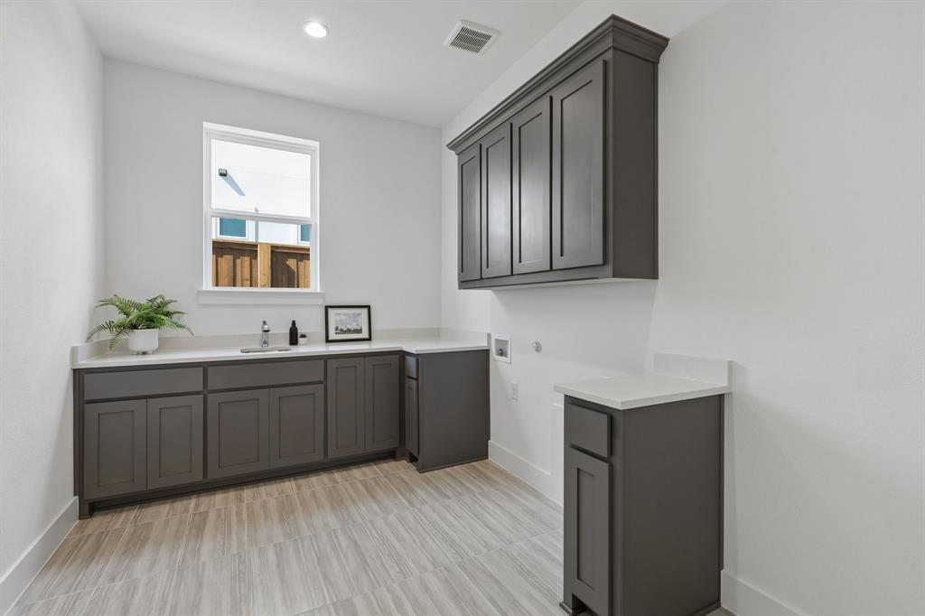 460 Harrison Lane Prosper, TX 75078 - Photo 26 of 40 Recessed lighting, wood-finish flooring, white countertops, built-in cabinetry, and a stainless steel sink