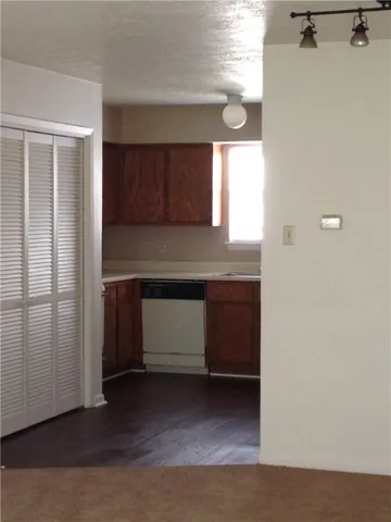 a kitchen with a refrigerator and window