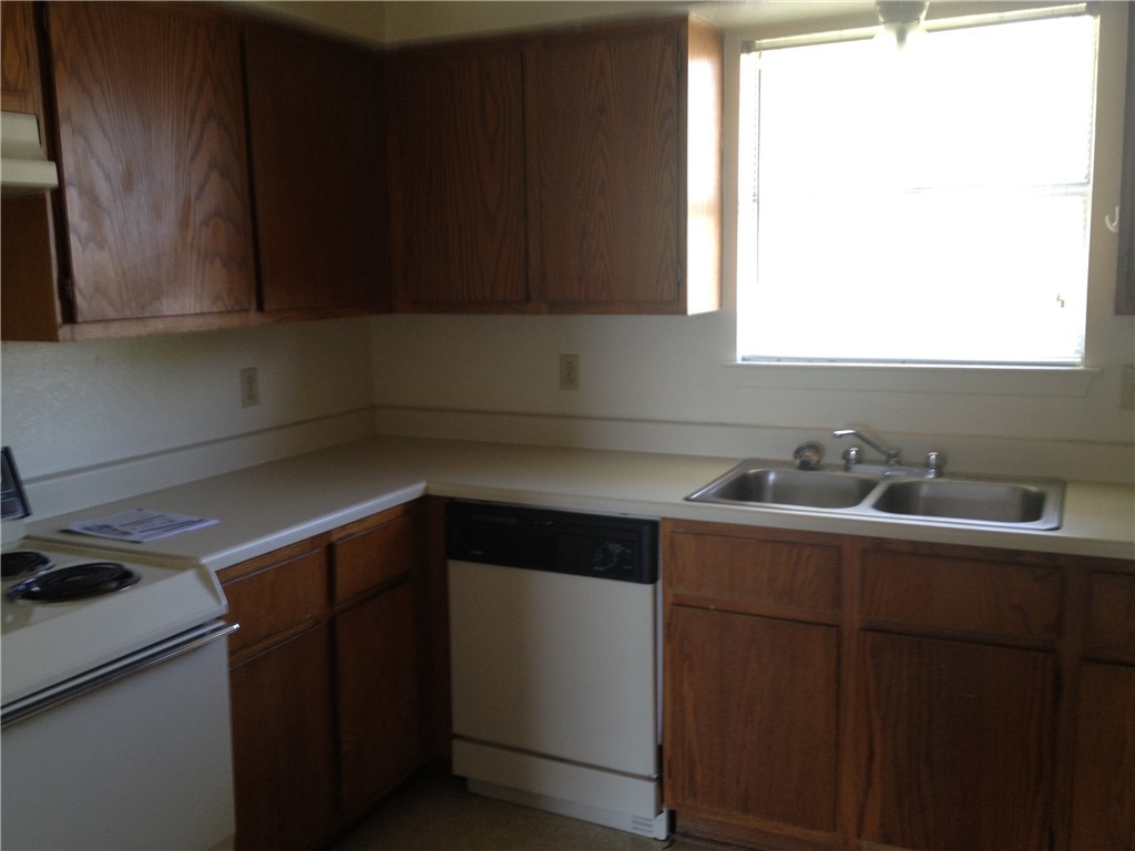 1110 Spring Loop, Unit D College Station, TX 77840 - Photo 8 of 9 a kitchen with a sink cabinets and a window