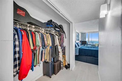 a view of walk in closet with clothes