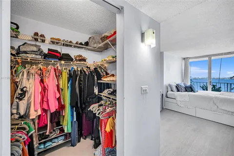 a view of walk in closet with clothes