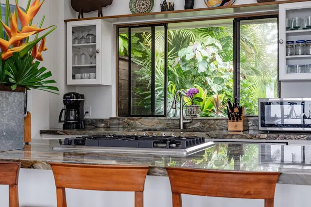 a view of a kitchen with kitchen island a large window and sink