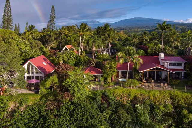 an aerial view of a houses with a yard