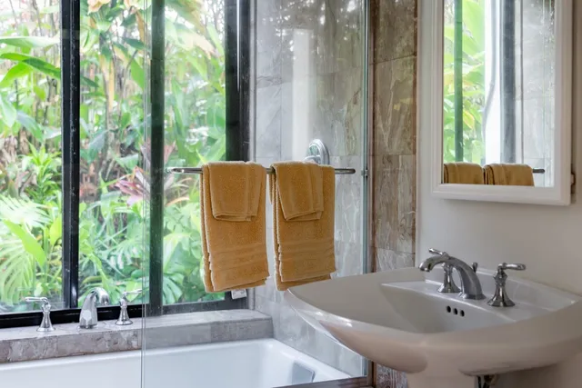 a bathroom with a sink a mirror and a window