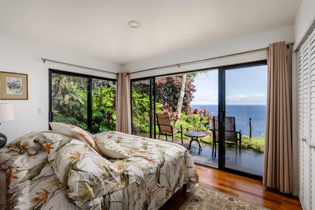 a bedroom with bed and a large window