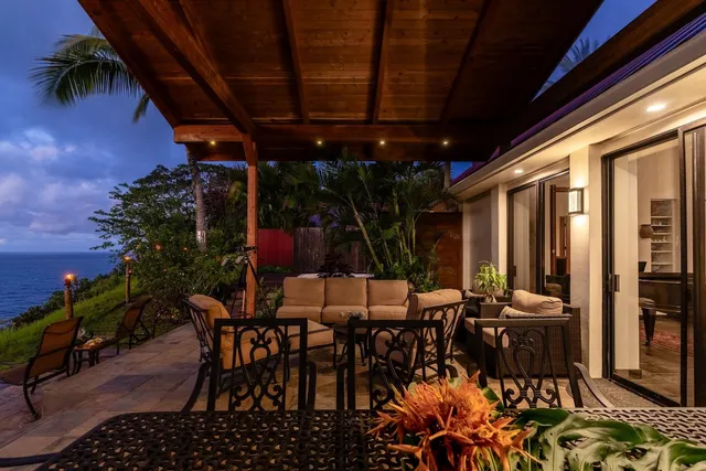a view of a house with a yard and sitting area