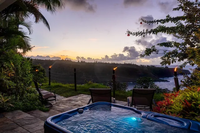 a swimming pool with lots of tress in the background