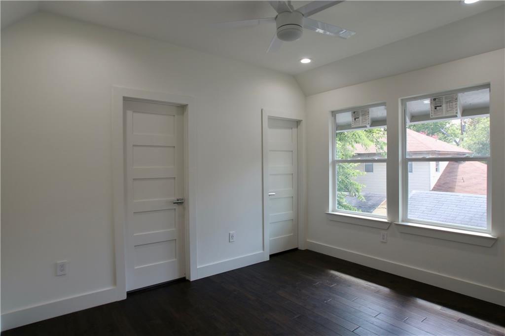 705 Harris Avenue, Unit A Austin, TX 78705 - Photo 11 of 33 an empty room with wooden floor and windows