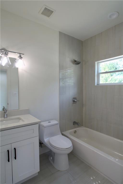 705 Harris Avenue, Unit A Austin, TX 78705 - Photo 22 of 33 a bathroom with a toilet a sink a mirror and a bathtub