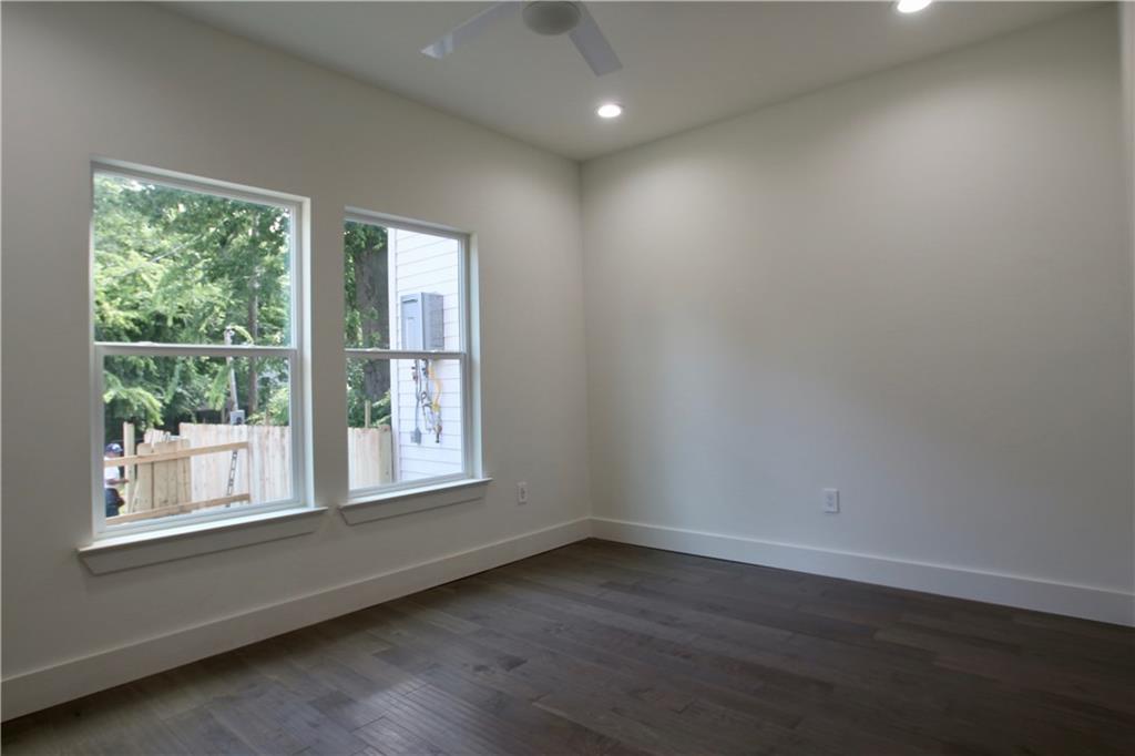 705 Harris Avenue, Unit A Austin, TX 78705 - Photo 23 of 33 a view of an empty room with wooden floor and a window