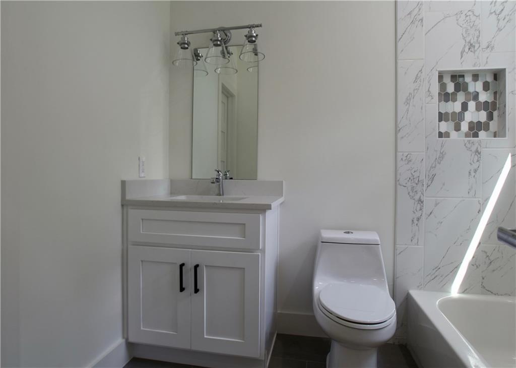 705 Harris Avenue, Unit A Austin, TX 78705 - Photo 25 of 33 a bathroom with a toilet sink and mirror
