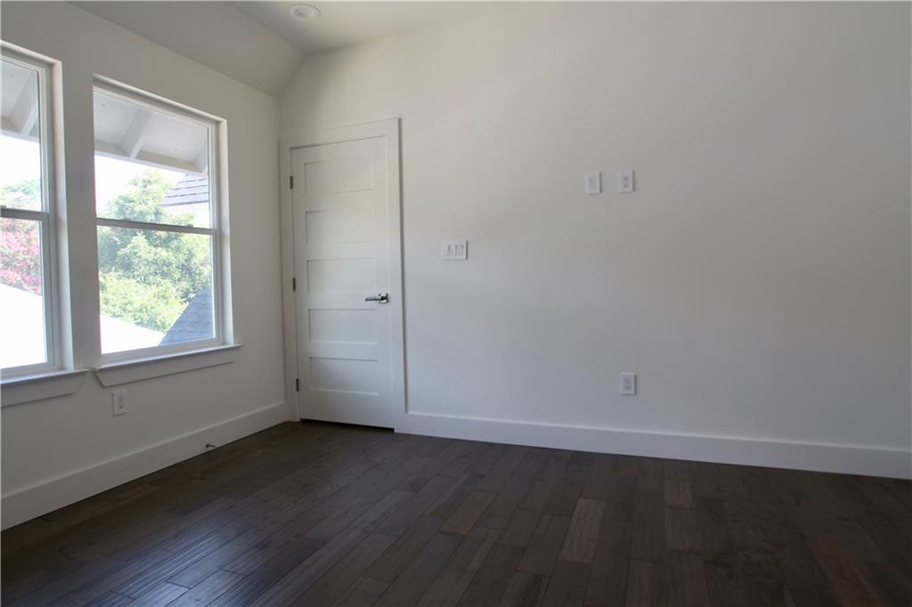 705 Harris Avenue, Unit A Austin, TX 78705 - Photo 29 of 33 an empty room with wooden floor and windows