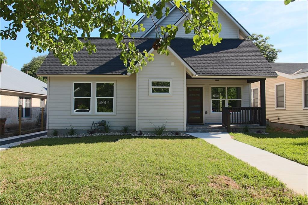 705 Harris Avenue, Unit A Austin, TX 78705 - Photo 31 of 33 a front view of a house with a yard