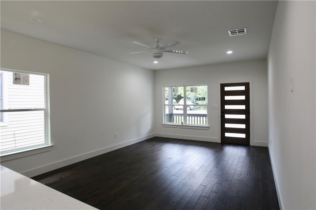 705 Harris Avenue, Unit A Austin, TX 78705 - Photo 7 of 33 wooden floor in an empty room with a window