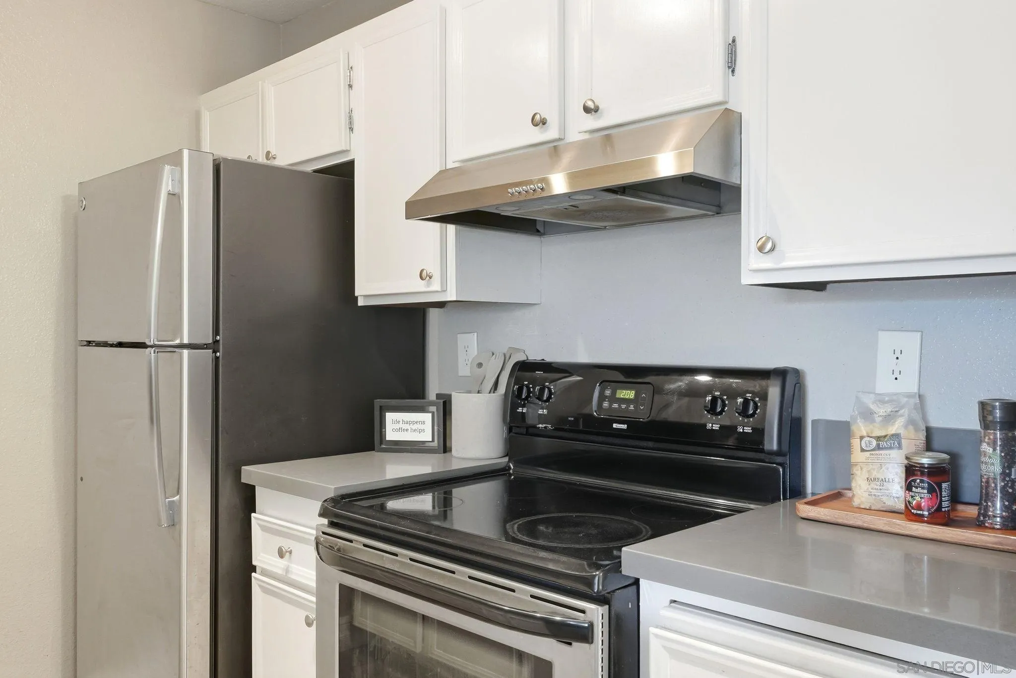 6111 Rancho Mission Road, Unit 209 San Diego, CA 92108 - Photo 11 of 20 a kitchen with stainless steel appliances granite countertop a refrigerator and a stove