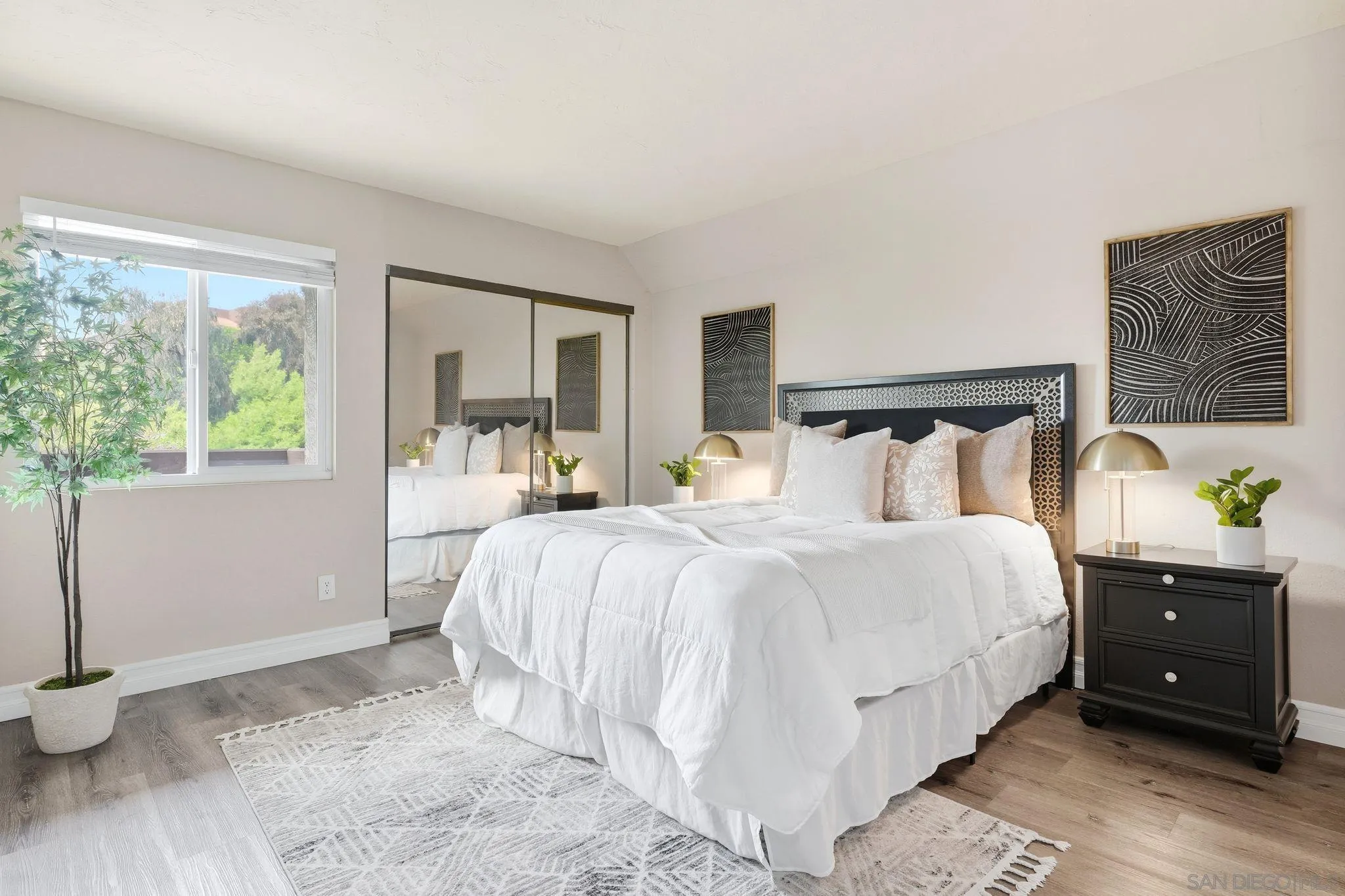 6111 Rancho Mission Road, Unit 209 San Diego, CA 92108 - Photo 13 of 20 a bedroom with a bed and a closet