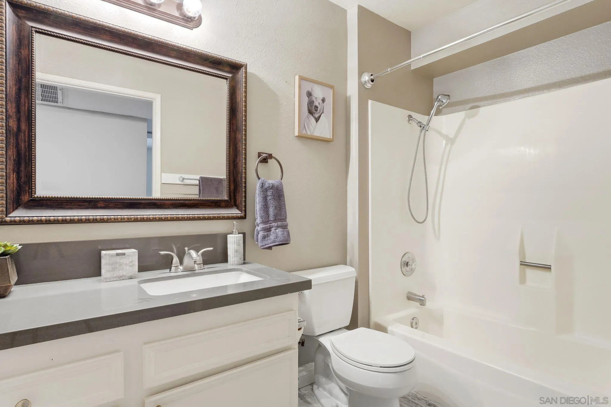 6111 Rancho Mission Road, Unit 209 San Diego, CA 92108 - Photo 14 of 20 a bathroom with a sink a toilet and a mirror