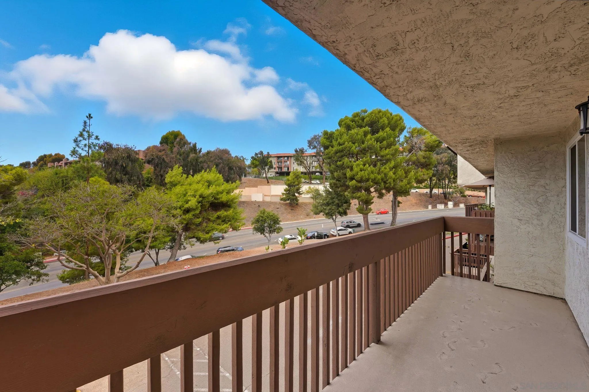 6111 Rancho Mission Road, Unit 209 San Diego, CA 92108 - Photo 17 of 20 a view of a balcony next to a yard