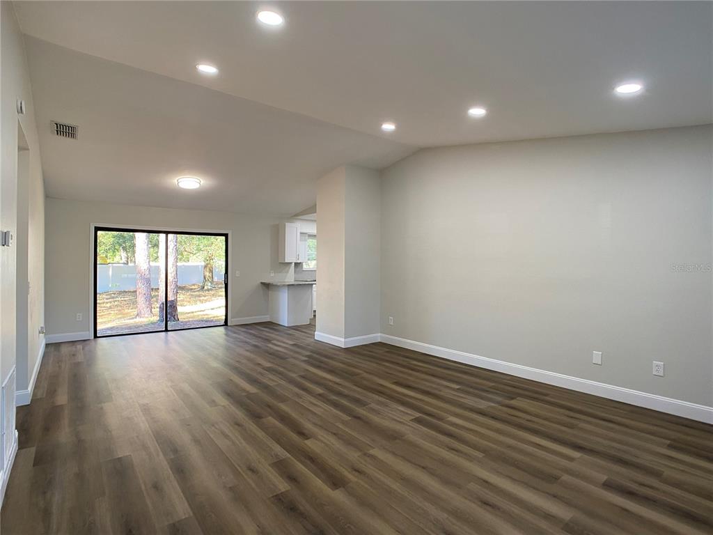 18 Midway Court Ocala, FL 34472 - Photo 17 of 38 an empty room with wooden floor and windows