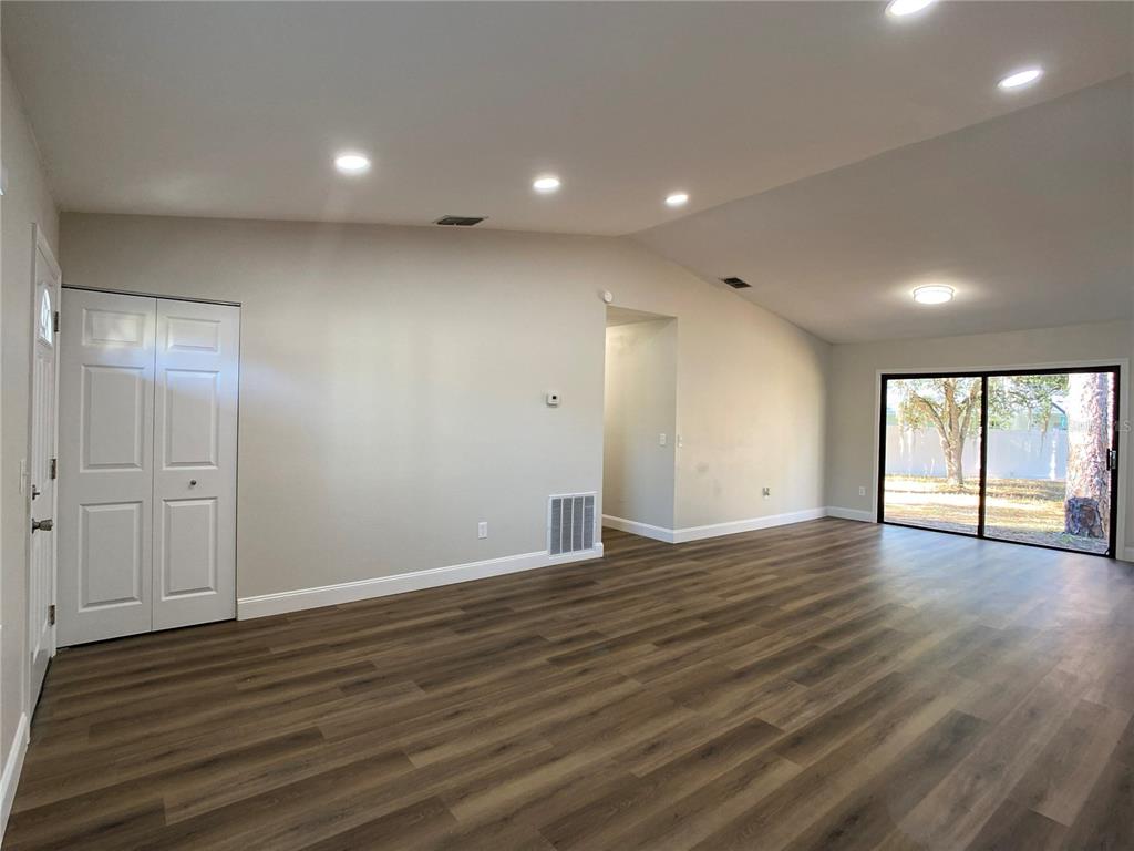 18 Midway Court Ocala, FL 34472 - Photo 18 of 38 a view of an empty room with wooden floor and a window