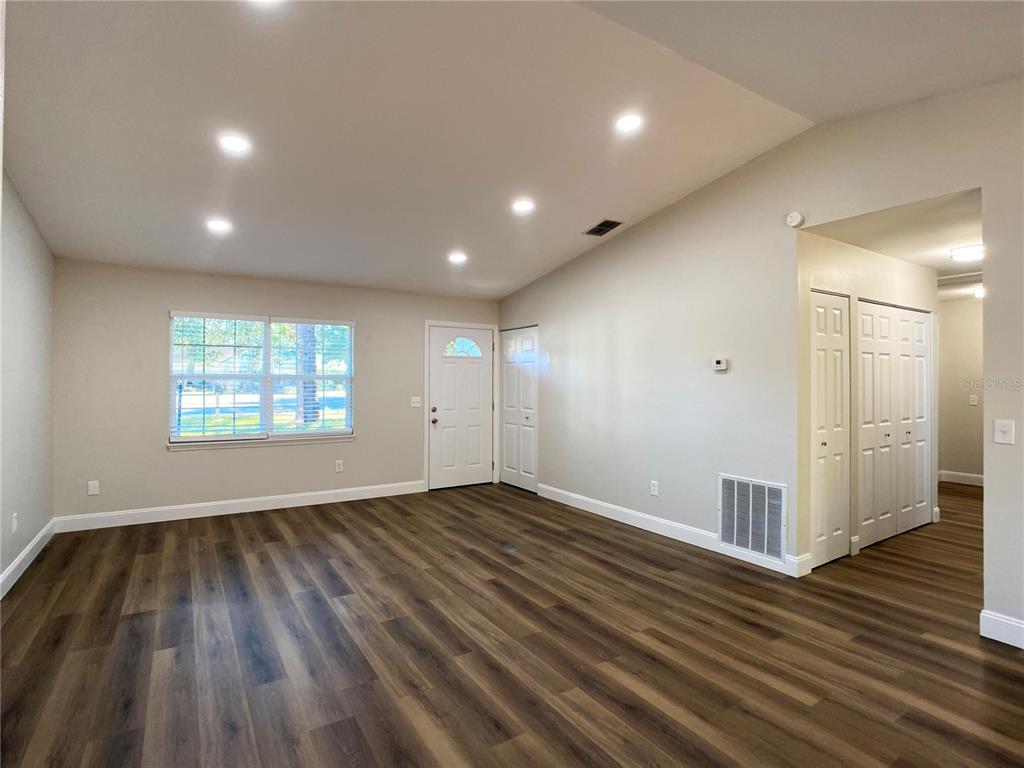 18 Midway Court Ocala, FL 34472 - Photo 19 of 38 an empty room with wooden floor and windows