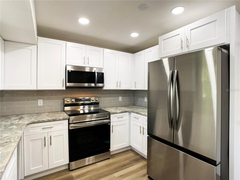 18 Midway Court Ocala, FL 34472 - Photo 23 of 38 a kitchen with stainless steel appliances a refrigerator stove and microwave