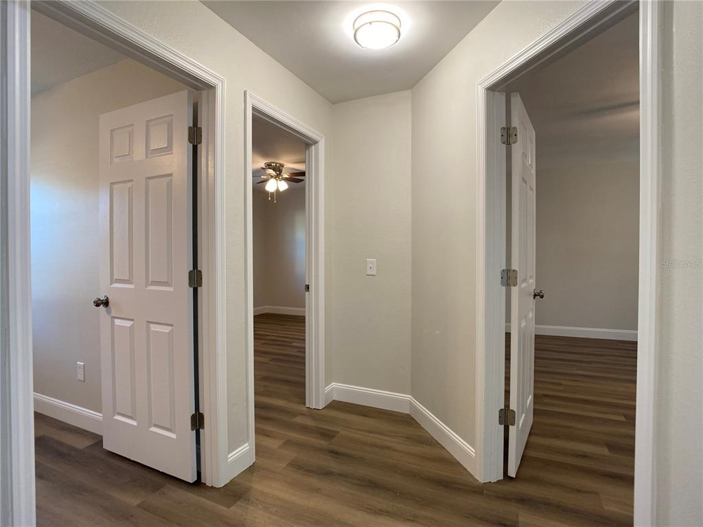 18 Midway Court Ocala, FL 34472 - Photo 27 of 38 a view of a hallway with wooden floor