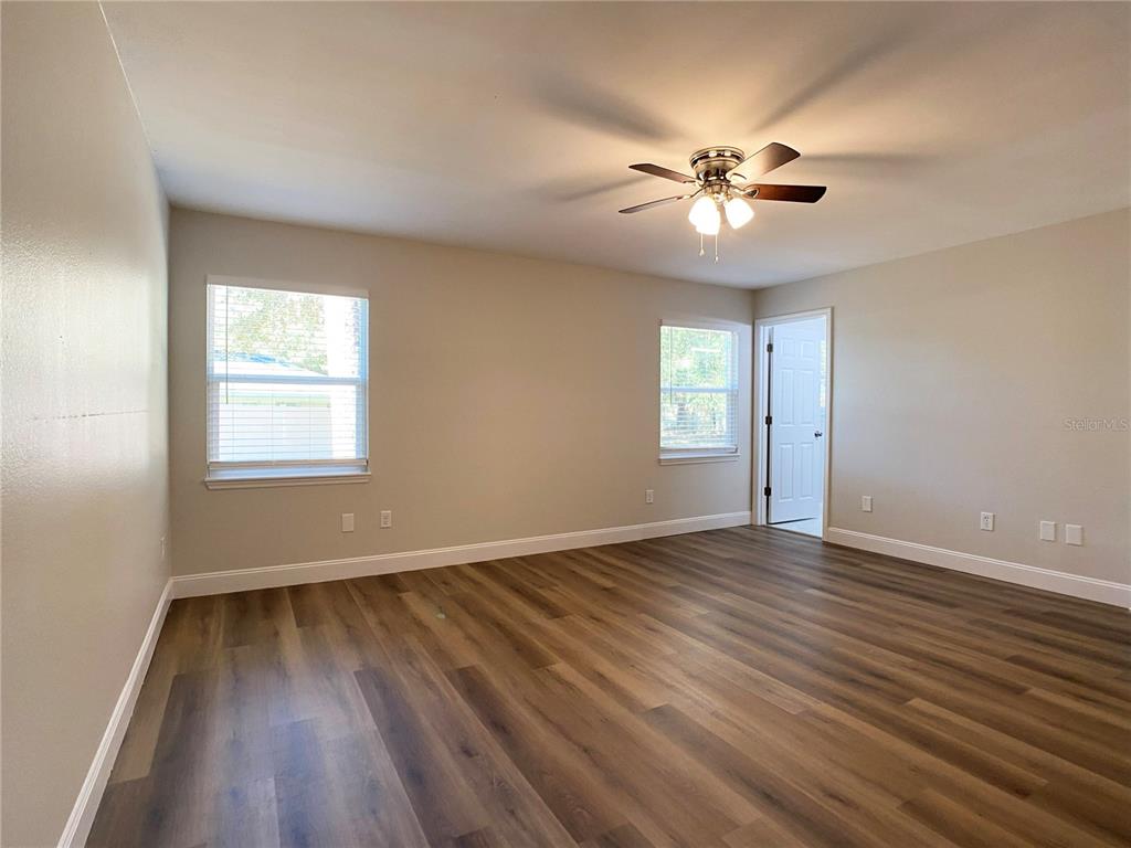 18 Midway Court Ocala, FL 34472 - Photo 32 of 38 a view of an empty room with wooden floor and a window