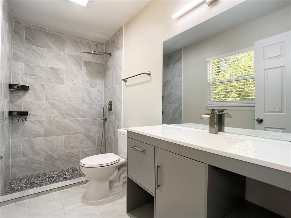 18 Midway Court Ocala, FL 34472 - Photo 33 of 38 a bathroom with a sink a toilet and shower