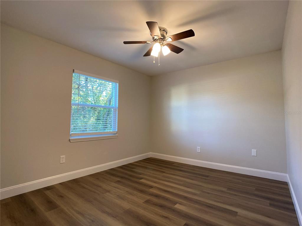 18 Midway Court Ocala, FL 34472 - Photo 35 of 38 an empty room with wooden floor fan and windows