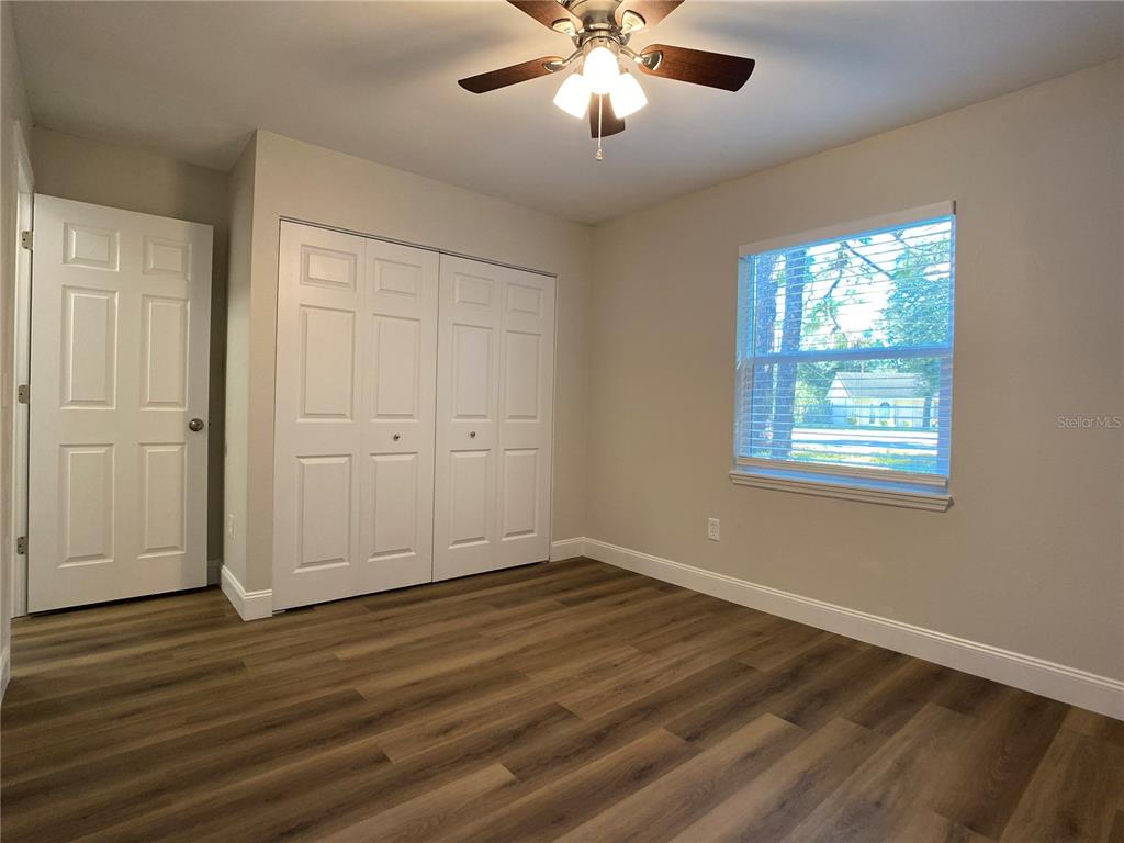 18 Midway Court Ocala, FL 34472 - Photo 36 of 38 a view of an empty room with wooden floor and a window