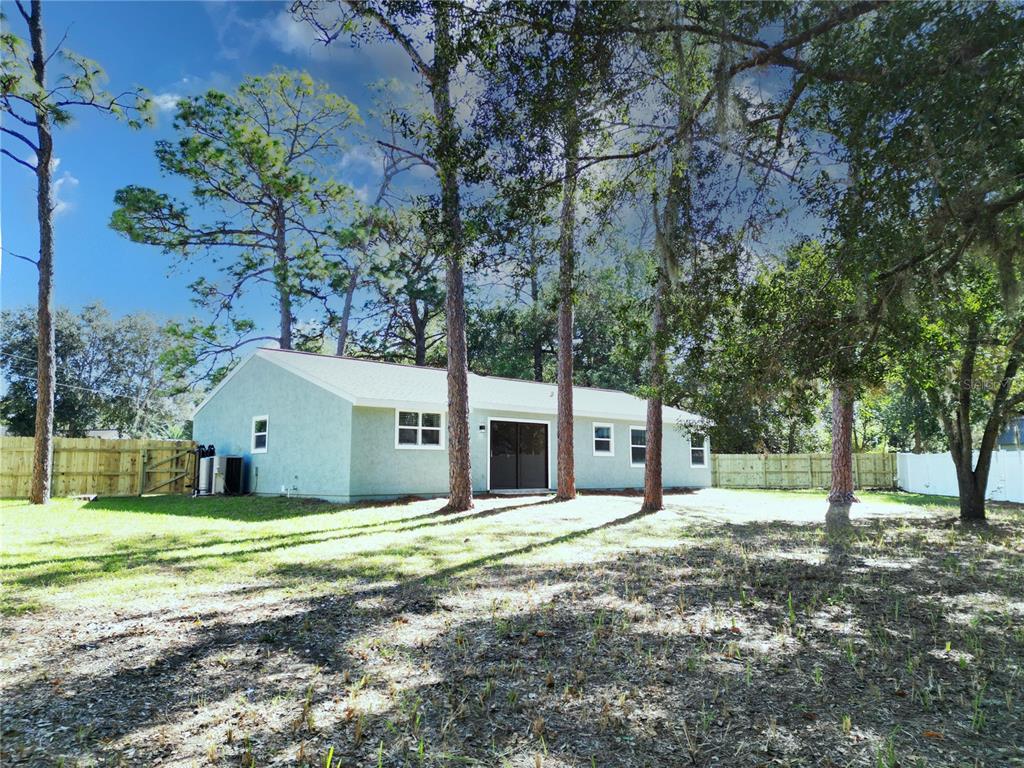 18 Midway Court Ocala, FL 34472 - Photo 8 of 38 a house with trees in front of it