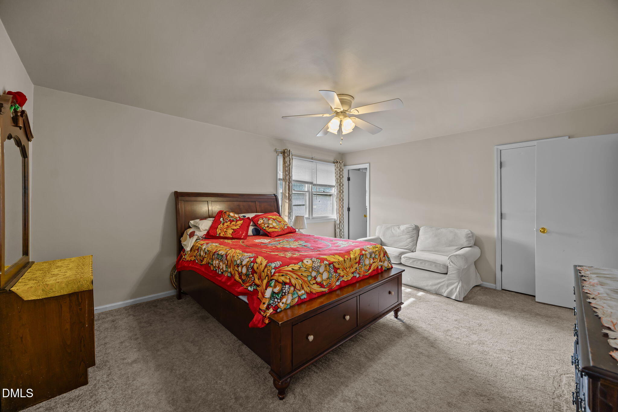 3256 North Old Franklin Road Spring Hope, NC 27882 - Photo 13 of 27 a bed sitting in a bedroom next to a window and a couch