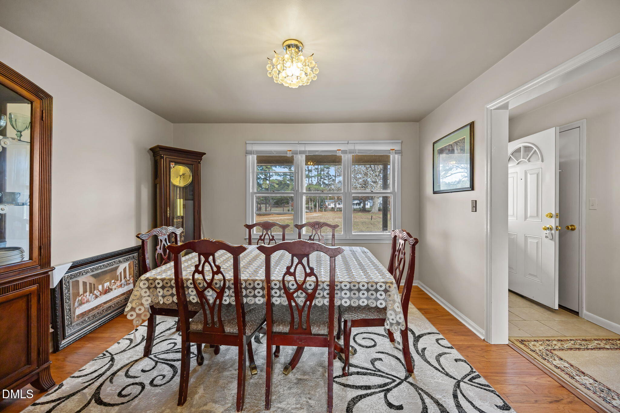 3256 North Old Franklin Road Spring Hope, NC 27882 - Photo 16 of 27 a view of a dining room with furniture a chandelier and wooden floor