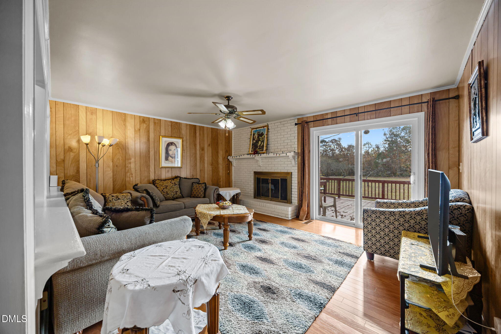 3256 North Old Franklin Road Spring Hope, NC 27882 - Photo 2 of 27 a living room with furniture a large window and a fireplace