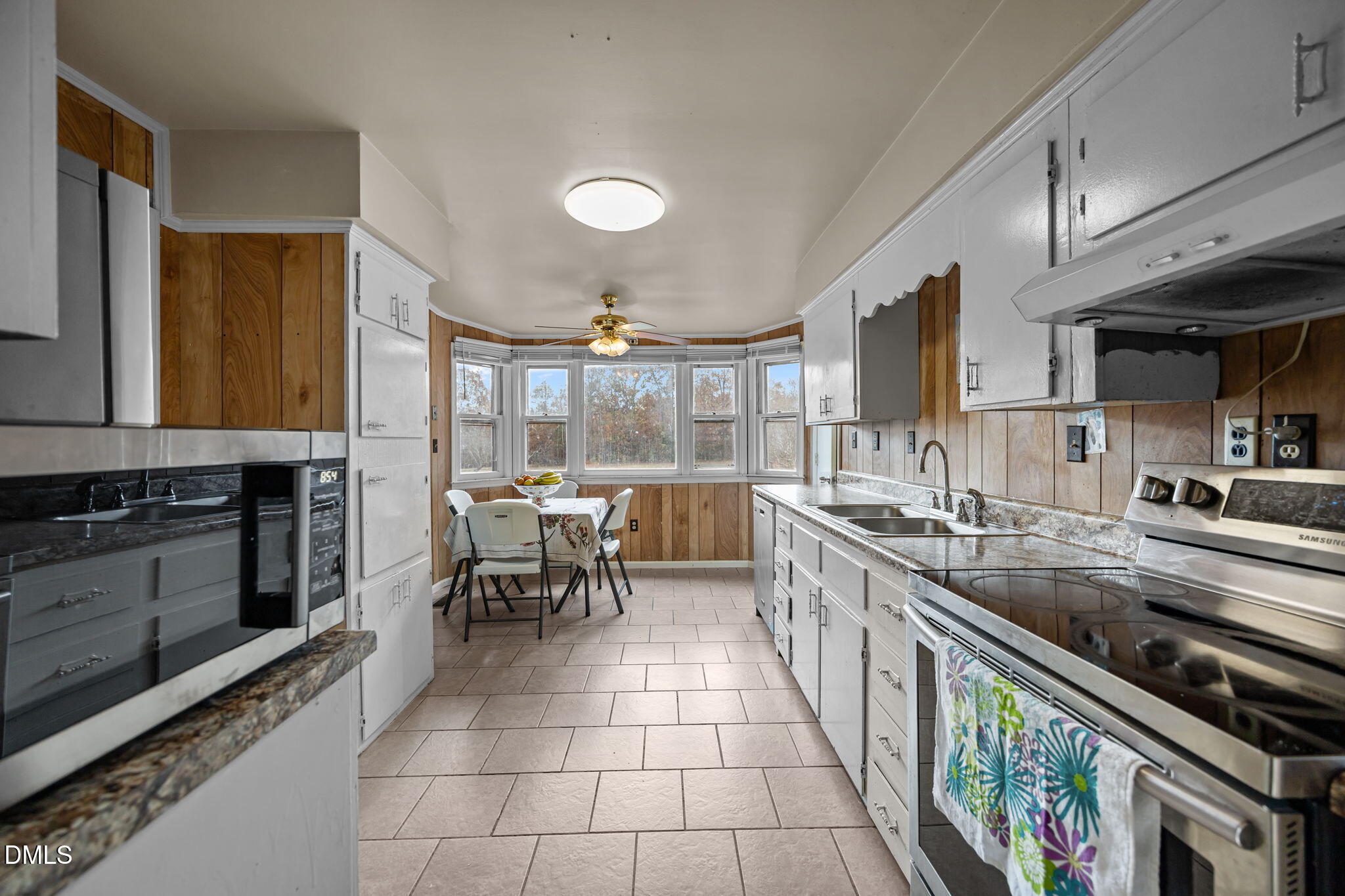 3256 North Old Franklin Road Spring Hope, NC 27882 - Photo 5 of 27 a kitchen with stainless steel appliances granite countertop a stove a sink and a microwave