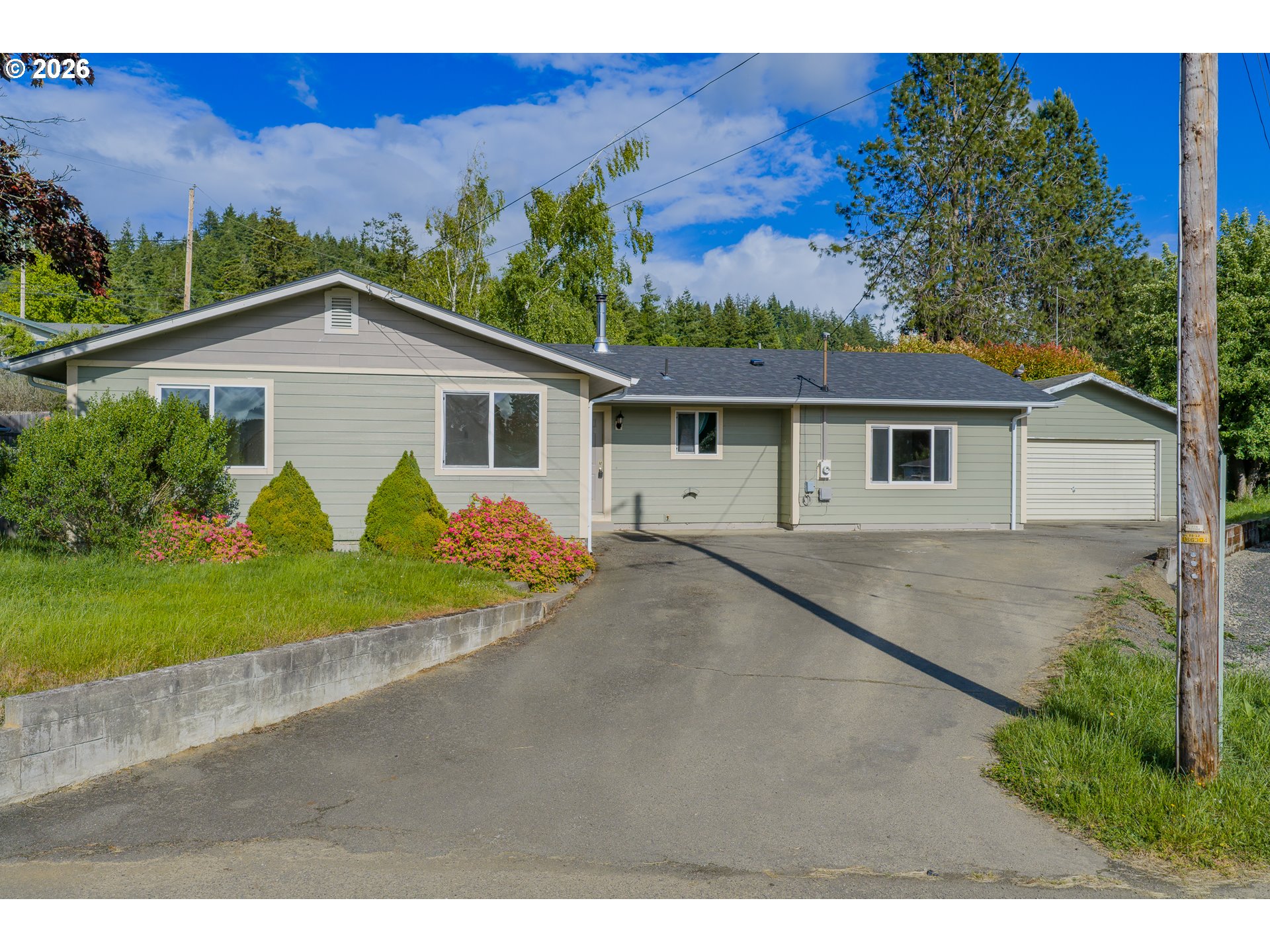 1816 Sunset Court Myrtle Point, OR 97458 - Photo 1 of 42 a view of a house with a yard and potted plants