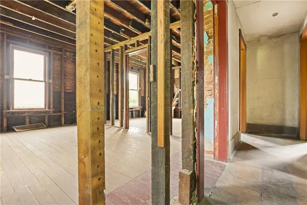 a view of a hallway with wooden floor and staircase