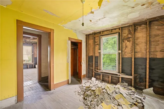 a bedroom with a bed and large windows