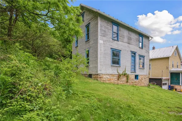 a view of a backyard with table and chairs and potted plants