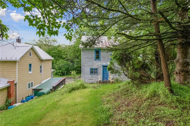a view of backyard of house with green space