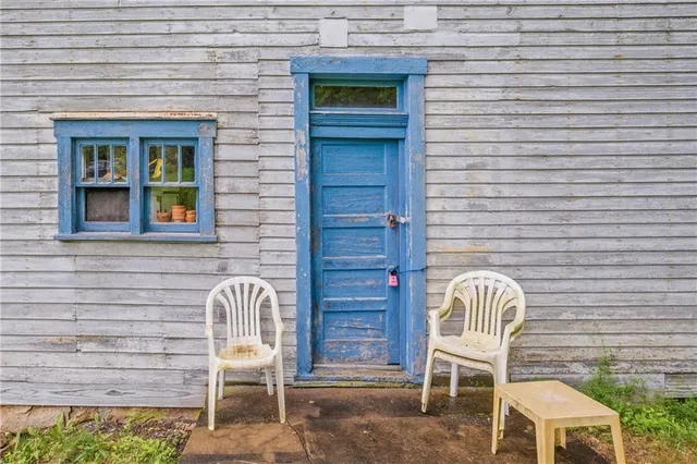 a couple of chairs in front of door